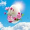 Easter egg with a sprig of blooming apple tree against a blue sky