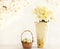 Easter eggs in a basket and bright yellow flowers daffodils. Vintage still