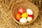 Easter eggs in the basket on straw backgrounds