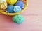 Easter eggs in a basket, straw, wooden colored
