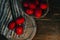 Easter eggs in a basket on a wooden table with a lit candle.