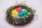 Easter eggs in beautiful nest on marble background.