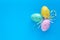 Easter eggs on a blue background, gift card with copy space, festive mockup. Colorful paschal egg