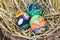 Easter eggs with bright drawing in a nest