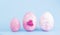 Easter eggs collection. Chicken eggs are painted pink isolated on a blue background. Creative card with Easter. Banner. Copy space