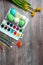 Easter eggs and colorful paints and brushes, decorative chickens