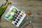 Easter eggs and colorful paints and brushes, decorative chickens