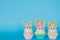 Easter eggs decorate as bunny dressing put on colorful cupcake paper cup and background.