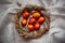 Easter Eggs Decorated with Natural Fresh Leaves and Boiled in Onions Peels on gray linen tablecloth in a wreath. Happy Easter conc