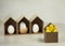 Easter eggs in decorative birdhouses with little yellow chickens in front of them