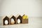 Easter eggs in decorative birdhouses with little yellow chickens near by