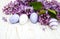 Easter eggs and fresh lilac flowers