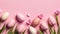 Easter eggs in a green egg holder with pink flowers on a pink background