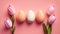 Easter eggs in a green egg holder with pink flowers on a pink background