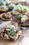 Easter eggs in nests. Easter decorations. Rustic surface. Selective focus