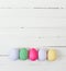 Easter eggs painted in pastel colors on white wood