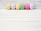 Easter eggs painted in pastel colors on white wood