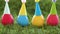 Easter eggs in party caps on artificial grass