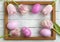 Easter eggs, photo frame, tulips on a white wooden background