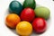 Easter eggs pile in white plate. Colorful, red, green ,blue, yellow and orange eggs. Top view
