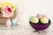 Easter eggs. Purple bowl with colorful eggs in matte colors. Light marble background