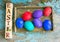 Easter eggs on rural blue moss background. wooden letters