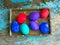 Easter eggs on rural blue moss background. wooden letters