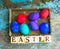 Easter eggs on rural blue moss background. wooden letters