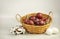 Easter eggs in a wicker basket on white background with cotton brunch