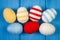 Easter eggs wrapped woolen string on blue wooden boards, decoration for Easter