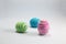 Easter eggs wrapped woolen string on a white wool background