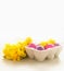 Easter eggs with yellow daffodils flowers at white background