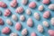 Easter Elegance: Pink and White Egg Pattern on Pastel Blue Background