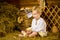 Easter fairy tale, a boy with chickens playing in a barn.