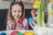 Easter, family, holiday and child concept - close up of little girl and mother coloring eggs for Easter