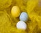 Easter, festive colored eggs on the bright yellow background