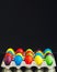 Easter festive multicolor eggs carton, black background