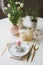 Easter festive table details. Dining place decorated in pink and gold tones