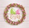 Easter Festive Twigs Wreath with Flowers on Wooden Background