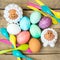 Easter flatlay, spoons, colorful dyed eggs and lamb figures on wooden table