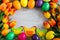 Easter frame background - close up of colorful eggs, decorative chicks and tulips