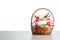 Easter gift basket with multicolor eggs, white background