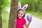 Easter girl with big purple egg and funny bunny ears