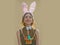 Easter girl with bunny ears and bow on beige background