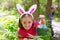 Easter girl with eggs basket and funny bunny face