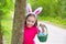 Easter girl with eggs basket and funny bunny face