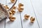 Easter golden eggs spilled out of wicker basket on white wooden table background