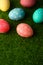 Easter greetings. Easter painted eggs on green grass. Easter religious holiday Easter. Vertical frame with space