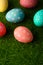 Easter greetings. Easter painted eggs on green grass. Easter religious holiday Easter. Vertical frame with space