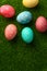 Easter greetings. Easter painted eggs on green grass. Easter religious holiday Easter. Vertical frame with space